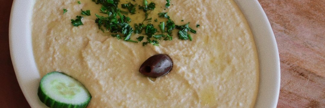 a bowl of hummus with vegetables